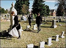 Madelyn and Anthony cleaning up the graveyard.